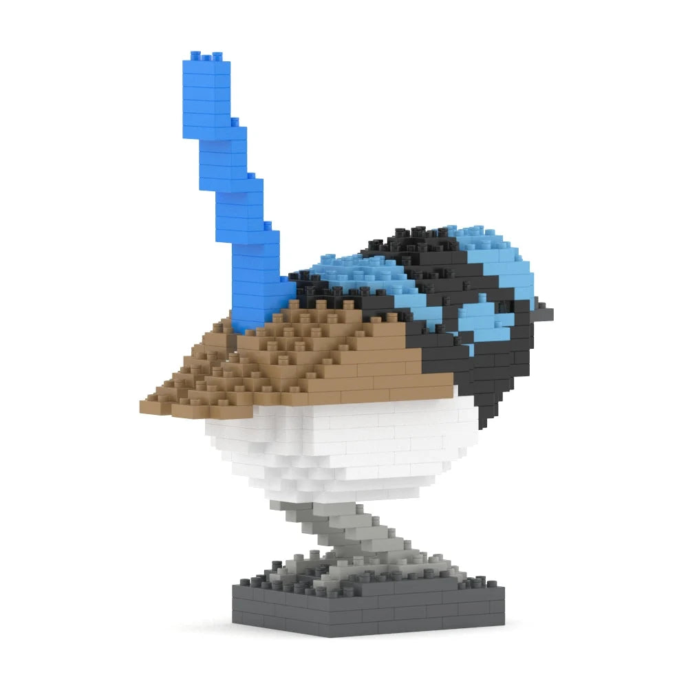 A 3D block puzzle model of a bird, constructed from interlocking diamond-shaped plastic blocks, featuring a brown beak, light blue crest, black and white body, and a gray base, shown on a solid white background.