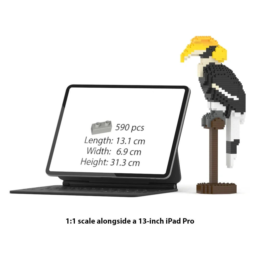 brick building toy set shown alongside a 13-inch iPad Pro for scale. The set includes a black tablet in a keyboard case displaying product info on its screen, and a pixelated great hornbill black-and-yellow bird perched on a brown stand.