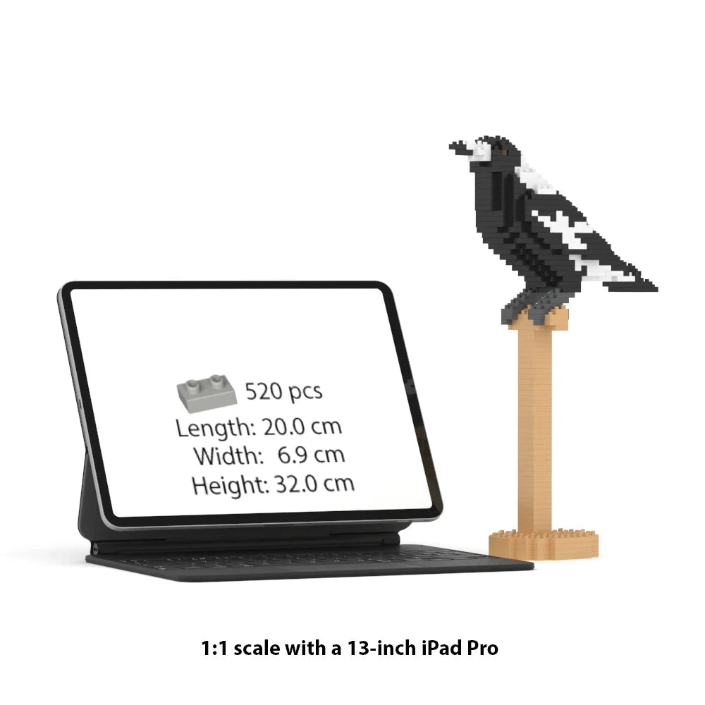 A brick building toy of Australian magpie set shown with a tablet displaying product details and a black-and-white bird model perched on a wooden stand. Text below reads '1:1 scale with a 13-inch iPad Pro'.