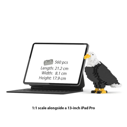 A 1:1 scale brick building set of an iPad Pro in a black tablet case with a built-in keyboard, shown next to a pixelated brick-built eagle on a white background. Text below reads '1:1 scale alongside a 13-inch iPad Pro'.