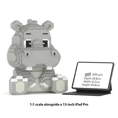 A 1:1 scale block-style hippo toy model shown beside a tablet displaying product specs. The hippo is built from light gray and white interlocking blocks and sits on a white background with text reading '1:1 scale alongside a 13-inch iPad Pro.