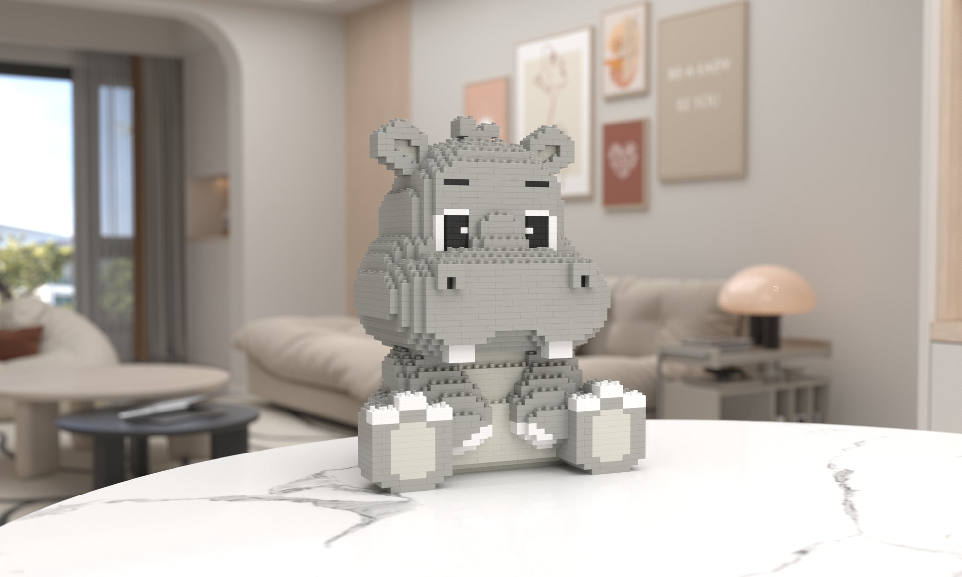 A small gray hippo toy built from interlocking blocks sits centered on a white marble table in a softly blurred modern living room.