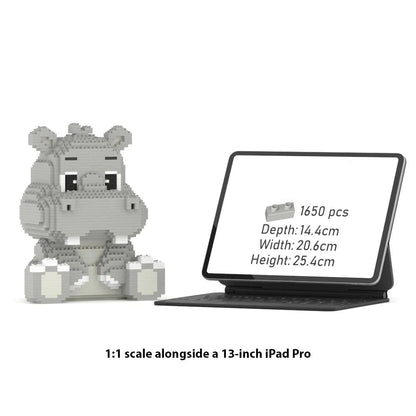 A gray hippo-shaped building block set displayed beside a tablet showing product details, with text below stating 1:1 scale alongside a 13-inch iPad Pro.
