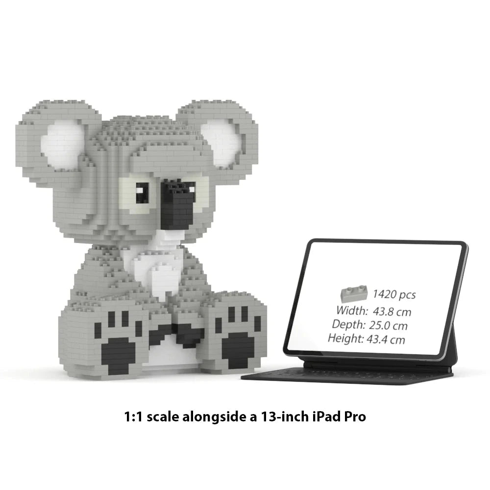 A gray and white koala brick building toy shown next to a tablet displaying product information, with text below reading '1:1 scale alongside a 13-inch iPad Pro'.