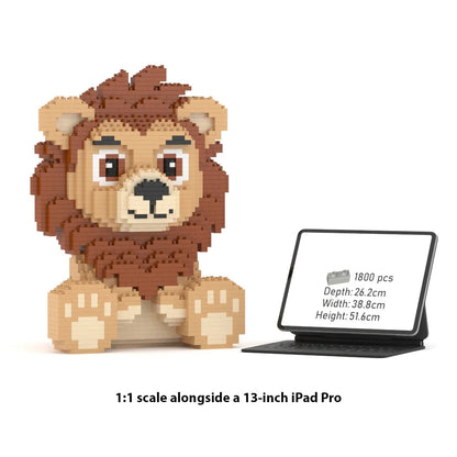 A 1:1 scale brick building toy lion made of small square blocks, shown next to a 13-inch iPad Pro displaying product specs. The lion is brown with beige paws and ears, and the iPad screen shows the dimensions.