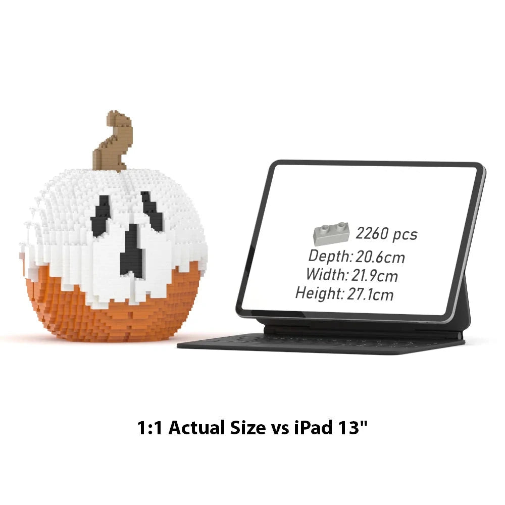 A LEGO-style pumpkin building set shown beside an iPad 13" with a black keyboard case. The pumpkin is made of white, orange, and brown block pieces with a carved face.