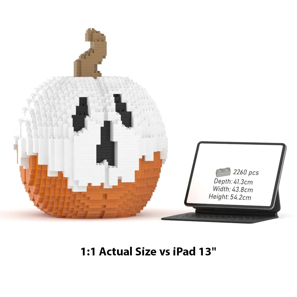 A brick-built jack-o'-lantern pumpkin model shown beside a tablet displaying its dimensions and piece count. The pumpkin has a white upper half, an orange lower half, and a brown stem.