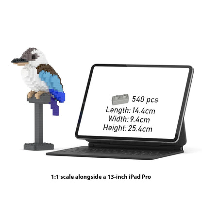 A 1:1 scale brick model of a kookaburra on a stand, shown next to a 13-inch iPad Pro displaying the product specifications. The text at the bottom reads '1:1 scale alongside a 13-inch iPad Pro'.