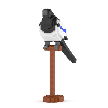 A small bird figurine built from block-like pieces, perched on a brown pole with a round base, shown on a plain white background.