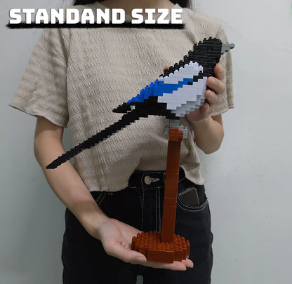 A person holding in hands a building block set of a magpie sculpture