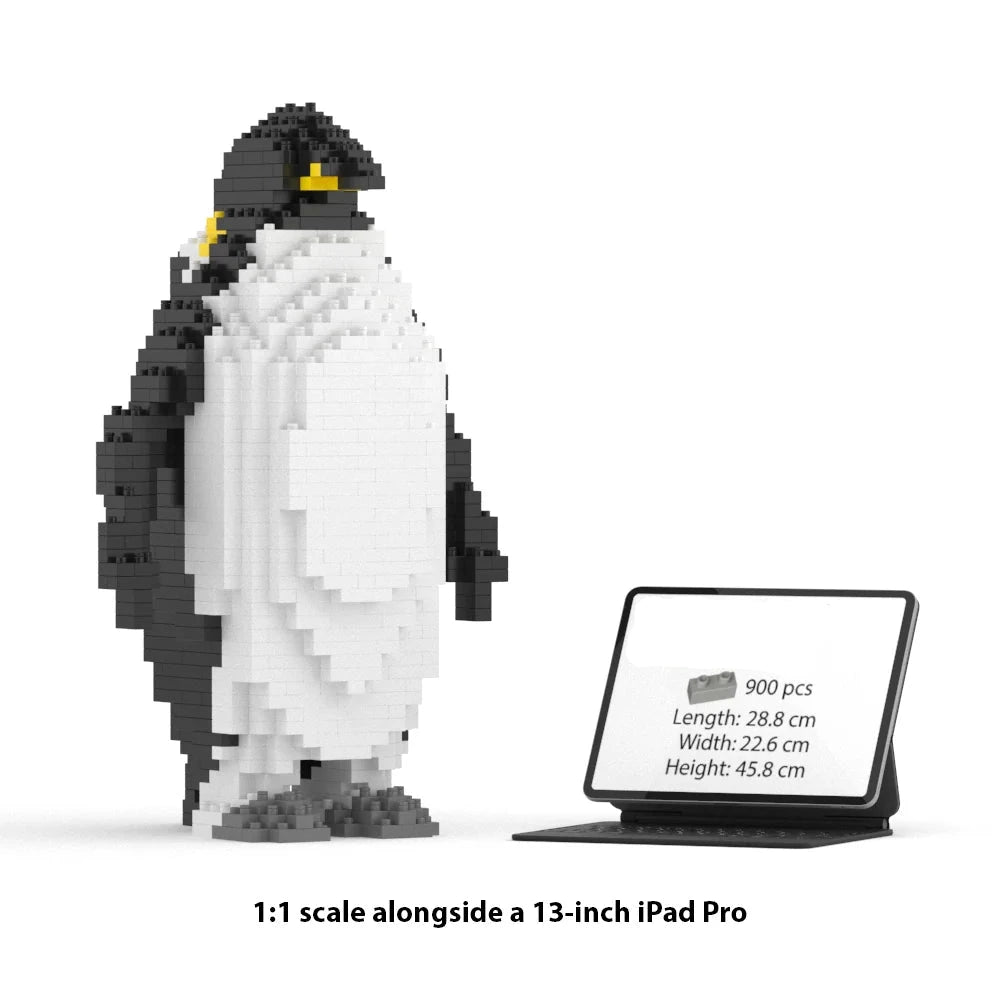 A 1:1 scale penguin building block model made of JEKCA blocks stands next to a 13-inch iPad Pro for scale comparison on a white background. Text at the bottom reads '1:1 scale alongside a 13-inch iPad Pro'.