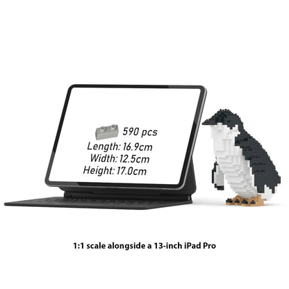 A 1:1 scale JEKCA penguin micro brick building set shown next to a 13-inch iPad Pro for scale comparison on a white background.