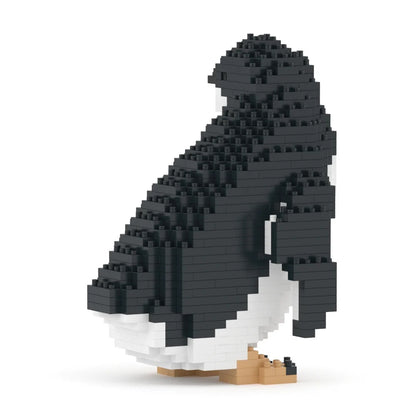 A penguin-shaped building block model constructed from black and white blocks with small tan feet, shown on a clean white background.