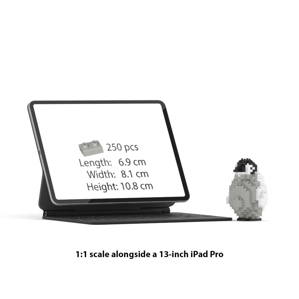 A black tablet stand holding a tablet with a screen displaying product info and a 250-piece brick set details, shown next to a small pixelated penguin figure on a white background with text reading '1:1 scale alongside a 13-inch iPad Pro'.