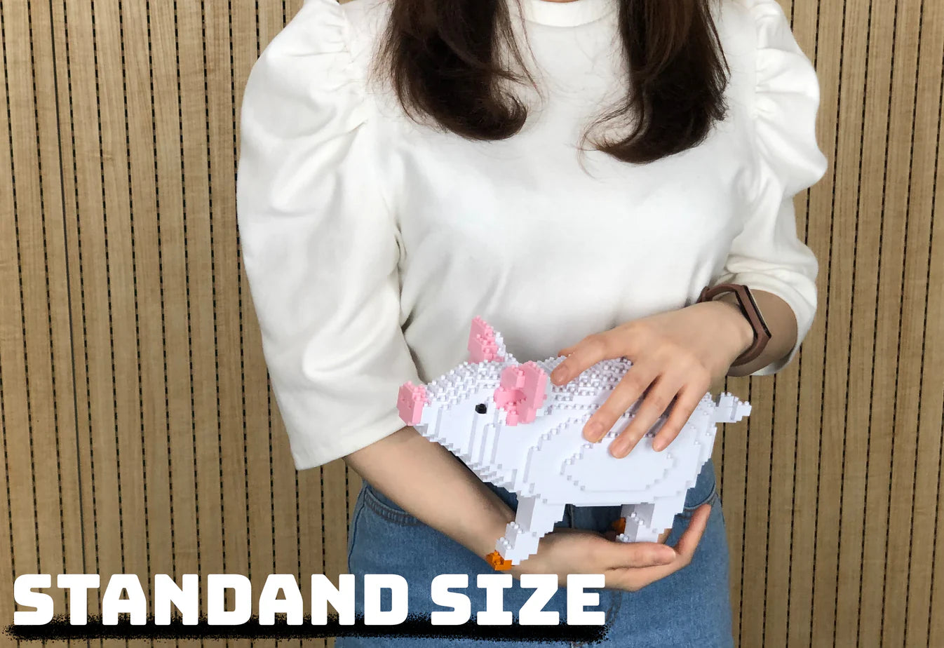 Woman holding in hands a standard size of a pig made from interlocking bricks