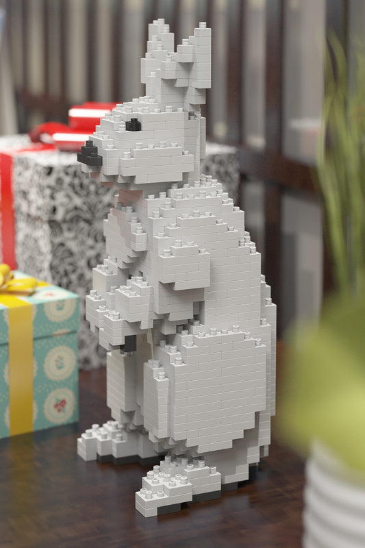 Rabbit made of interlocking bricks on a wooden surface with gift boxes in the background