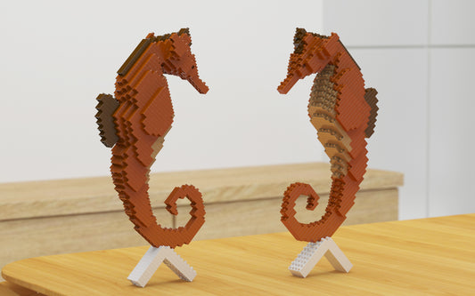Two seahorse-shaped objects made of interlocking bricks on a wooden surface.