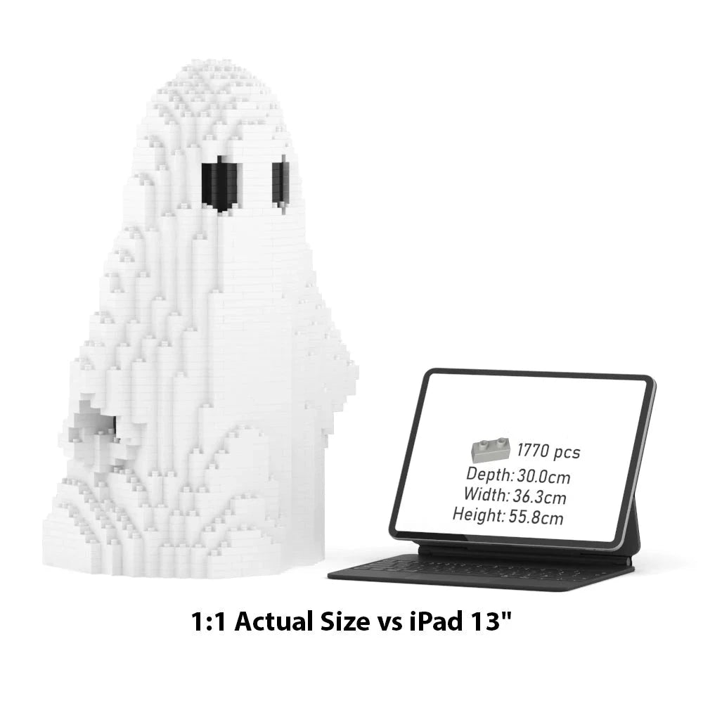 A white pixelated ghost-shaped building block model shown beside a tablet displaying its dimensions, with text below reading '1:1 Actual Size vs iPad 13"'. The tablet screen shows the product dimensions.