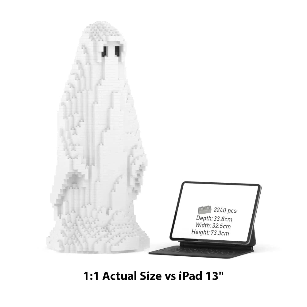 White brick-built ghost figurine shown next to a tablet displaying its actual dimensions, with text below reading '1:1 Actual Size vs iPad 13"'.