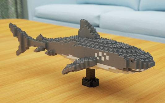 Sculpture of a tiger shark made of interlocking bricks on the wooden table